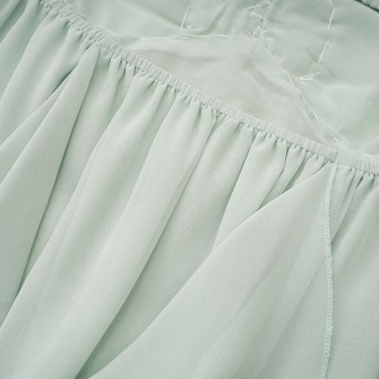 A midi dress with ruffles and embellishments called Salilah featuring a feminine silhouette and decorative details