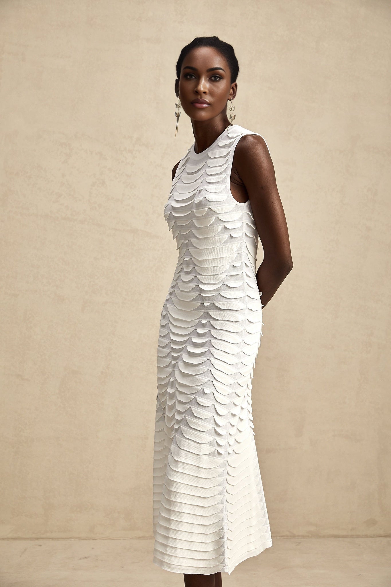 A midi length dress with a snake pattern design featuring godet inserts and called the Anna dress