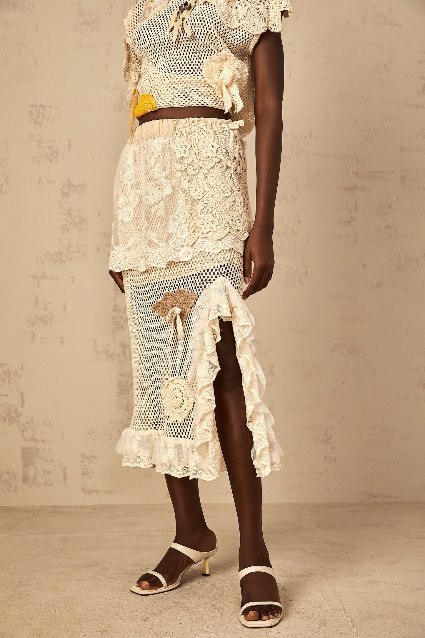 A midi length skirt with a combination of crochet knit fabric and lace panels named Lea