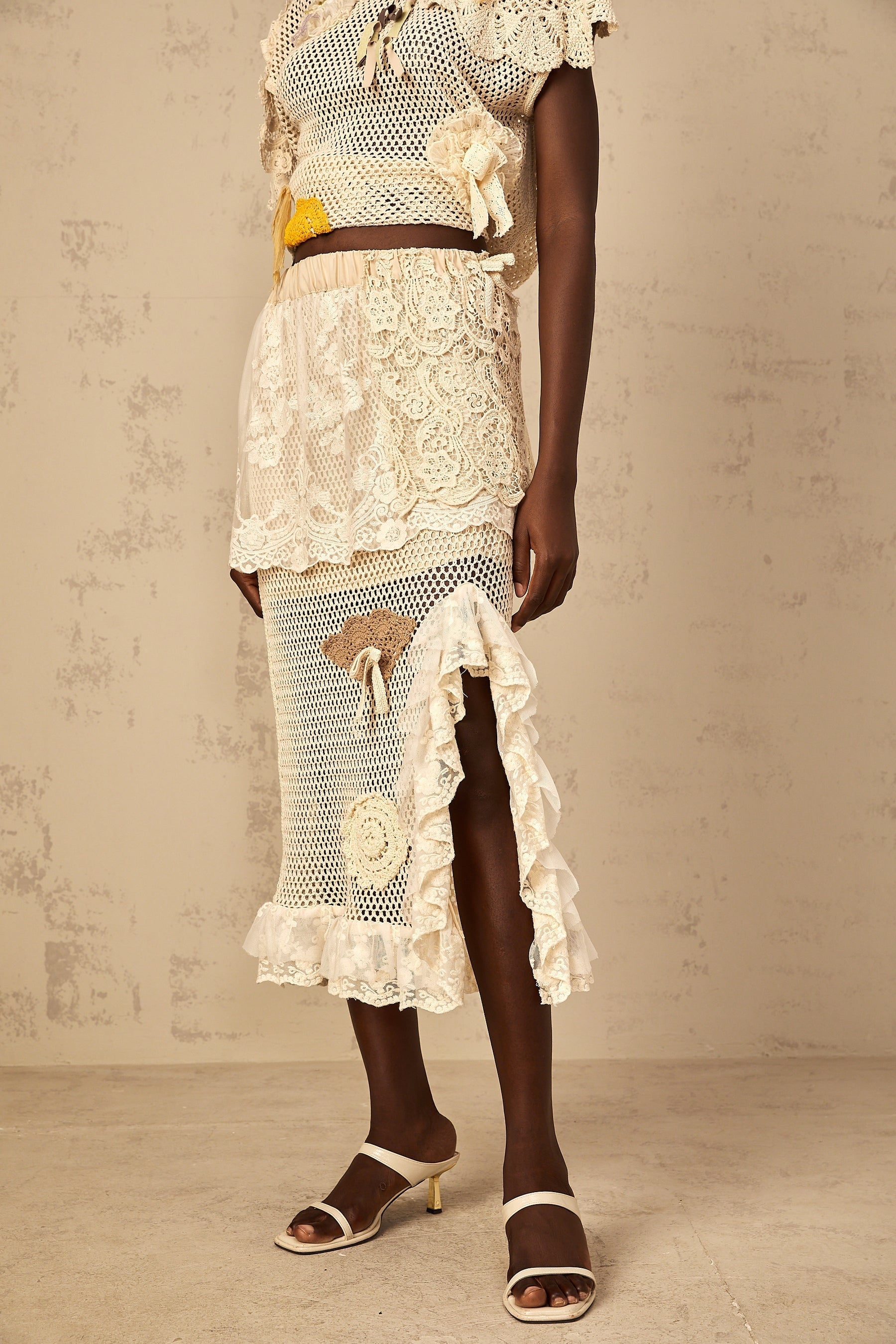 A midi length skirt with a combination of crochet knit fabric and lace panels named Lea