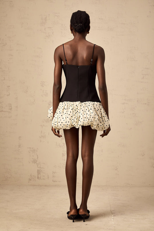 A mini dress with a color block design featuring polka dots and a decorative bow accent named Berengere