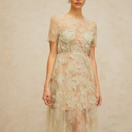 A mintgreen midi dress with floral lace pattern and a feminine silhouette