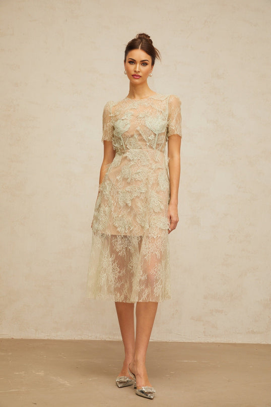 A mintgreen midi dress with floral lace pattern and feminine silhouette