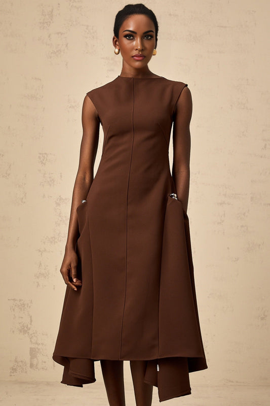 A model wearing a brown asymmetrical midi dress with a flowing skirt and fitted bodice