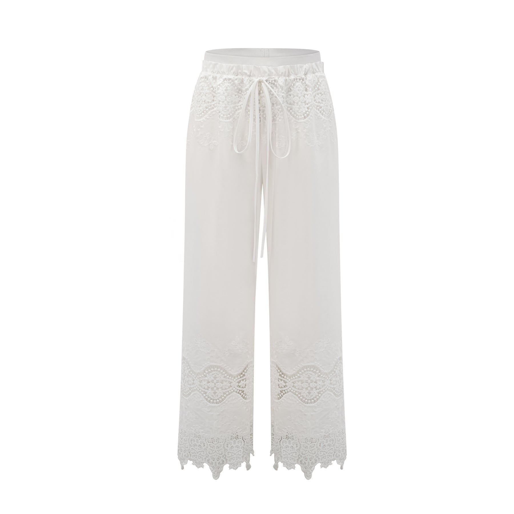 A model wearing a matching set consisting of a cropped top and trousers in white The top features lace trim and cutout details The trousers are high waisted and flared The set has a romantic and feminine style