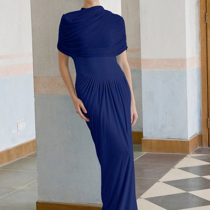 A navy blue asymmetric maxi dress with pleated details and a flowing silhouette