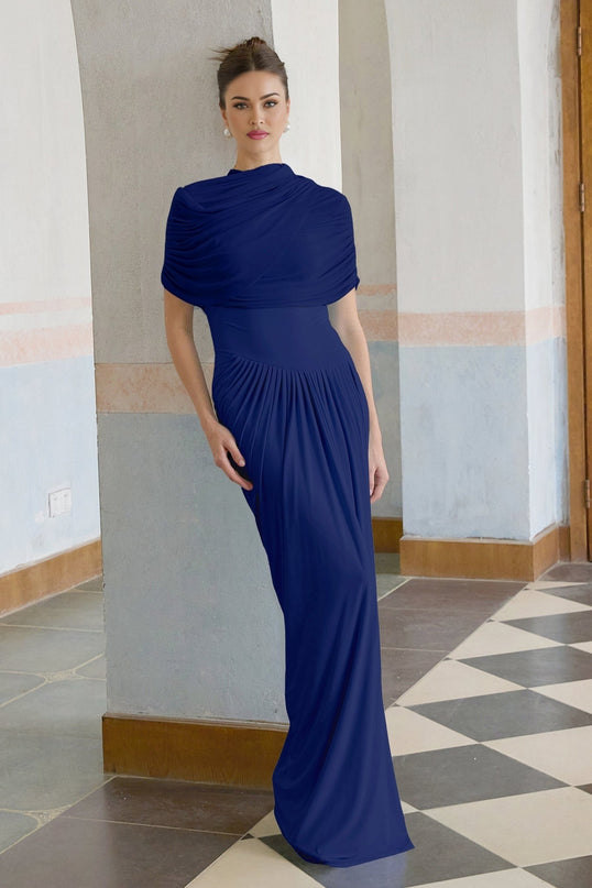A navy blue asymmetric maxi dress with pleated details and a flowing silhouette