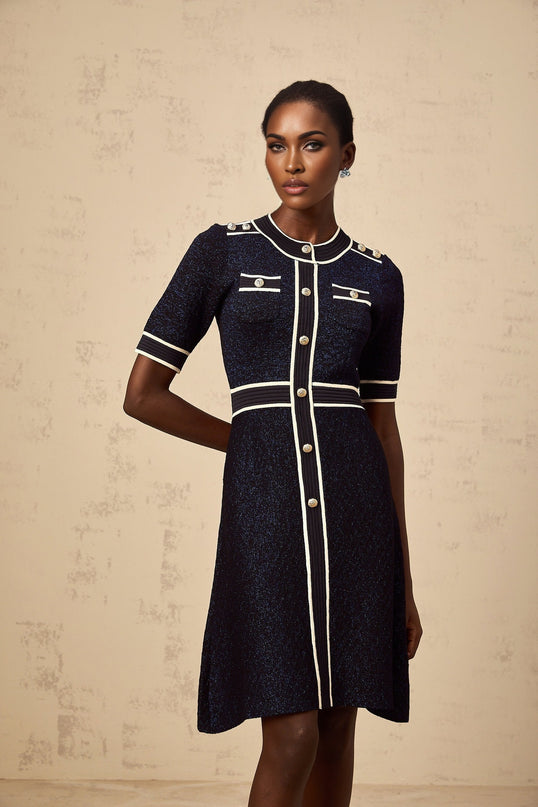 A navyblue mini dress with a glittery knit fabric called Paulette featuring a short hemline and sparkly finish