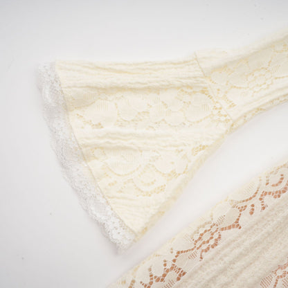 A neutral colored mini dress with floral lace pattern and flared cuffs called Emeline