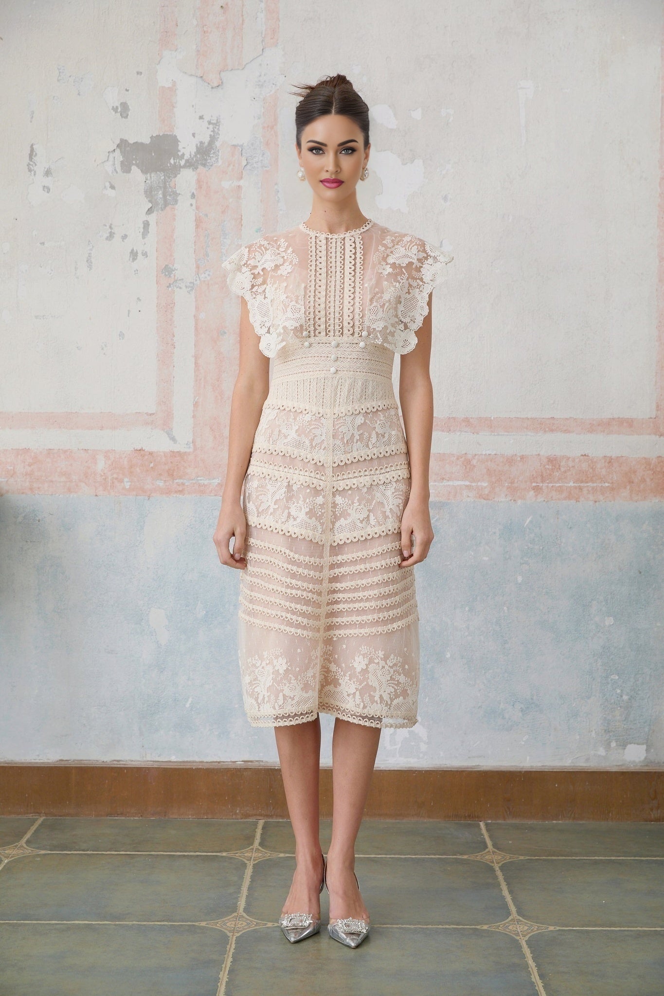 A neutralcolored midi dress with floral embroidery and lace details featuring a delicate fleur pattern