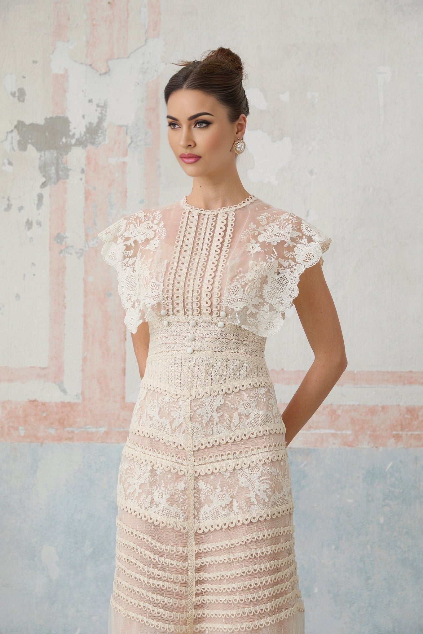 A neutralcolored midi dress with floral embroidery and lace details featuring a delicate fleur pattern
