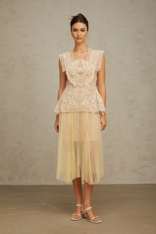 A neutraltoned midi dress with floral lace panels and tulle fabric featuring a delicate Celeste design