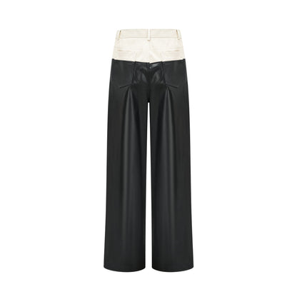 A pair of leather trousers featuring contrasting colors with the name Clotilde