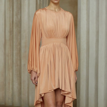 A pink asymmetrical midi dress with pleated details featuring a oneshoulder design and flowing skirt