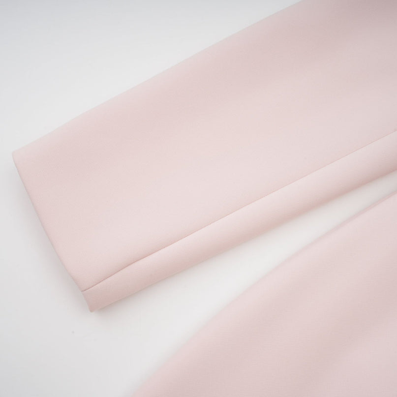 A pink crystal midi dress with colorblocked design featuring the name Anais