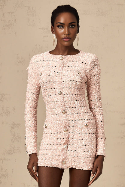 A pink fitted knit mini dress on a model showing the formfitting silhouette and short length