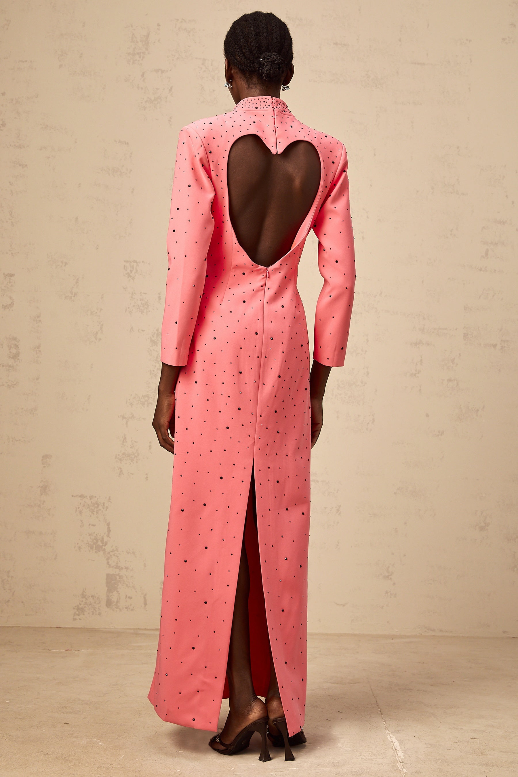 A pink maxi dress with heart shaped cutouts and embellishments named Zelie