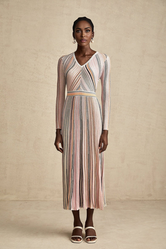 A pink metallic midi dress with pleated fabric named Mathilde featuring a shimmering finish and falling to mid calf length