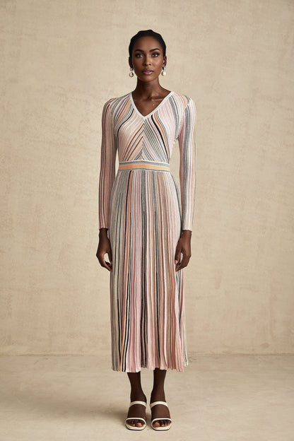 A pink metallic midi dress with pleated fabric named Mathilde featuring a shimmering finish and falling to mid calf length