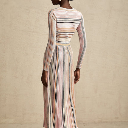 A pink metallic midi dress with pleated fabric named Mathilde featuring a shimmery finish and flowing design
