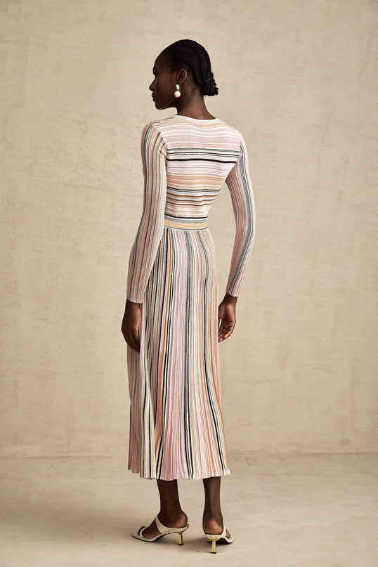 A pink metallic midi dress with pleated fabric named Mathilde featuring a shimmery finish and flowing design