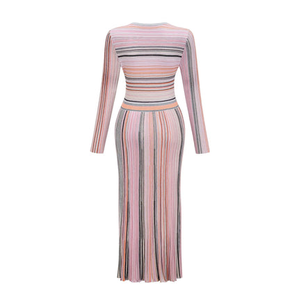 A pink metallic pleated midi dress named Mathilde featuring a shimmering fabric and flowing skirt length that falls below the knee