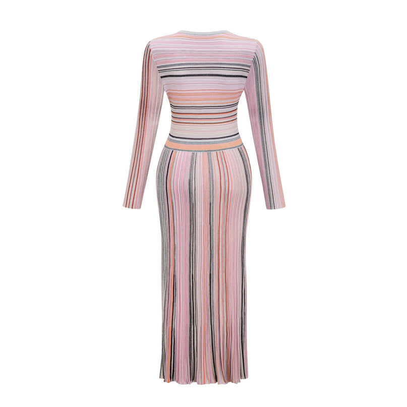 A pink metallic pleated midi dress named Mathilde featuring a shimmering fabric and flowing skirt length that falls below the knee