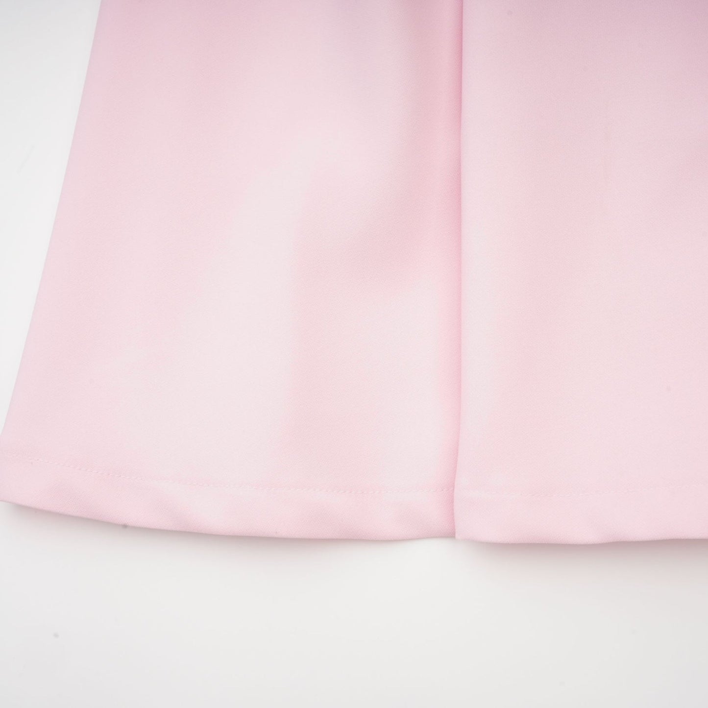 A pink midi dress with a bow detail and crystal accents inspired by the Cassiopeia constellation