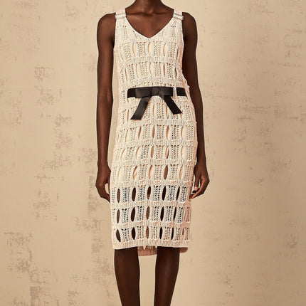 A pink midi dress with a crochet knit pattern and a decorative bowknot detail