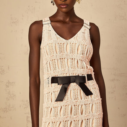 A pink midi dress with a crochet knit pattern featuring a decorative bowknot detail