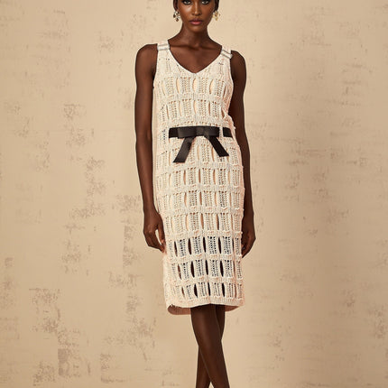 A pink midi dress with a crochet knit pattern featuring a decorative bowknot detail