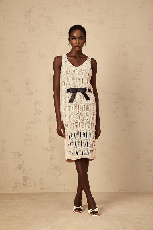 A pink midi dress with a crochet knit pattern featuring a decorative bowknot detail