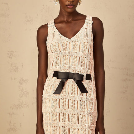 A pink midi dress with a crochet knit pattern featuring a decorative bowknot detail