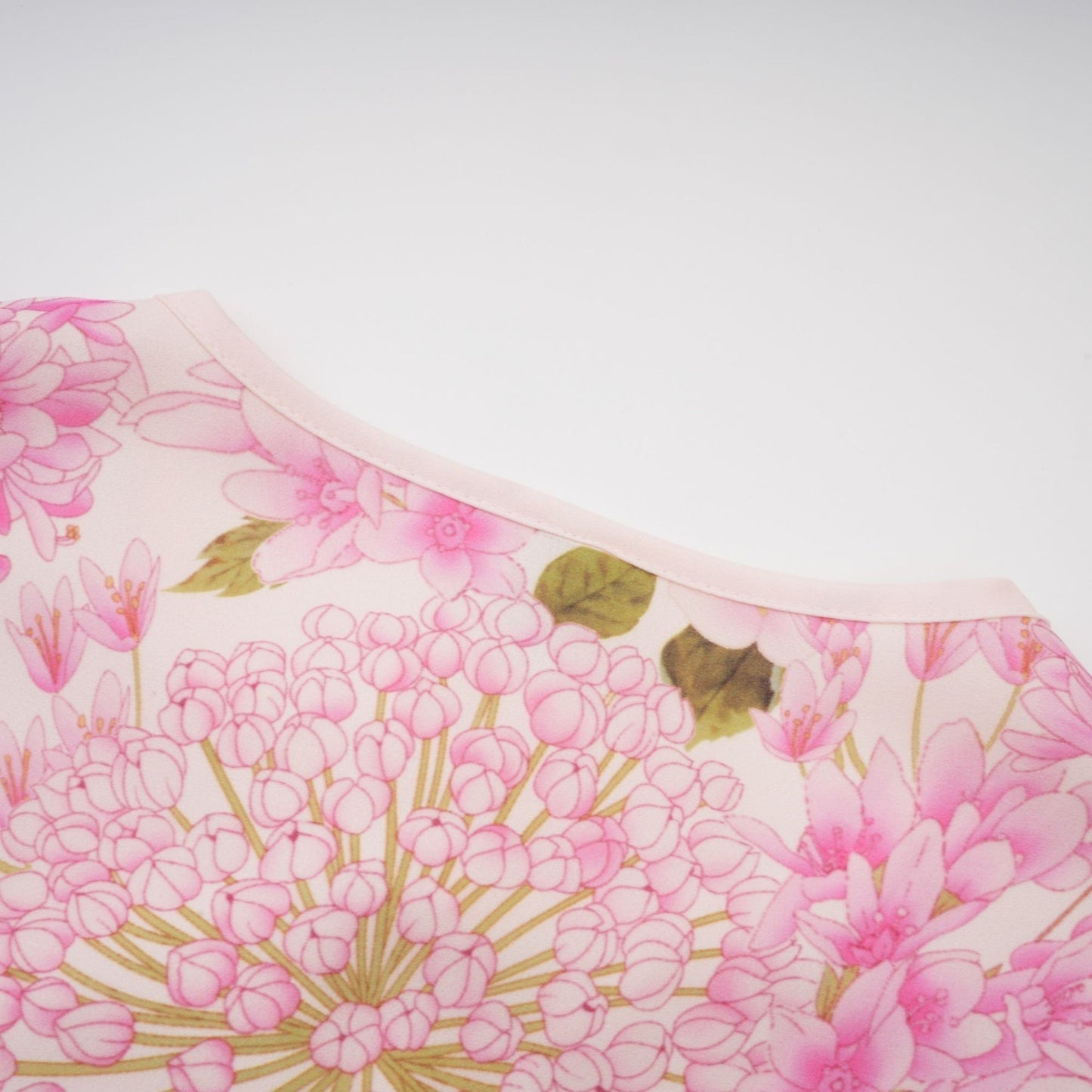 A pink midi dress with a floral print pattern featuring the name Yvette