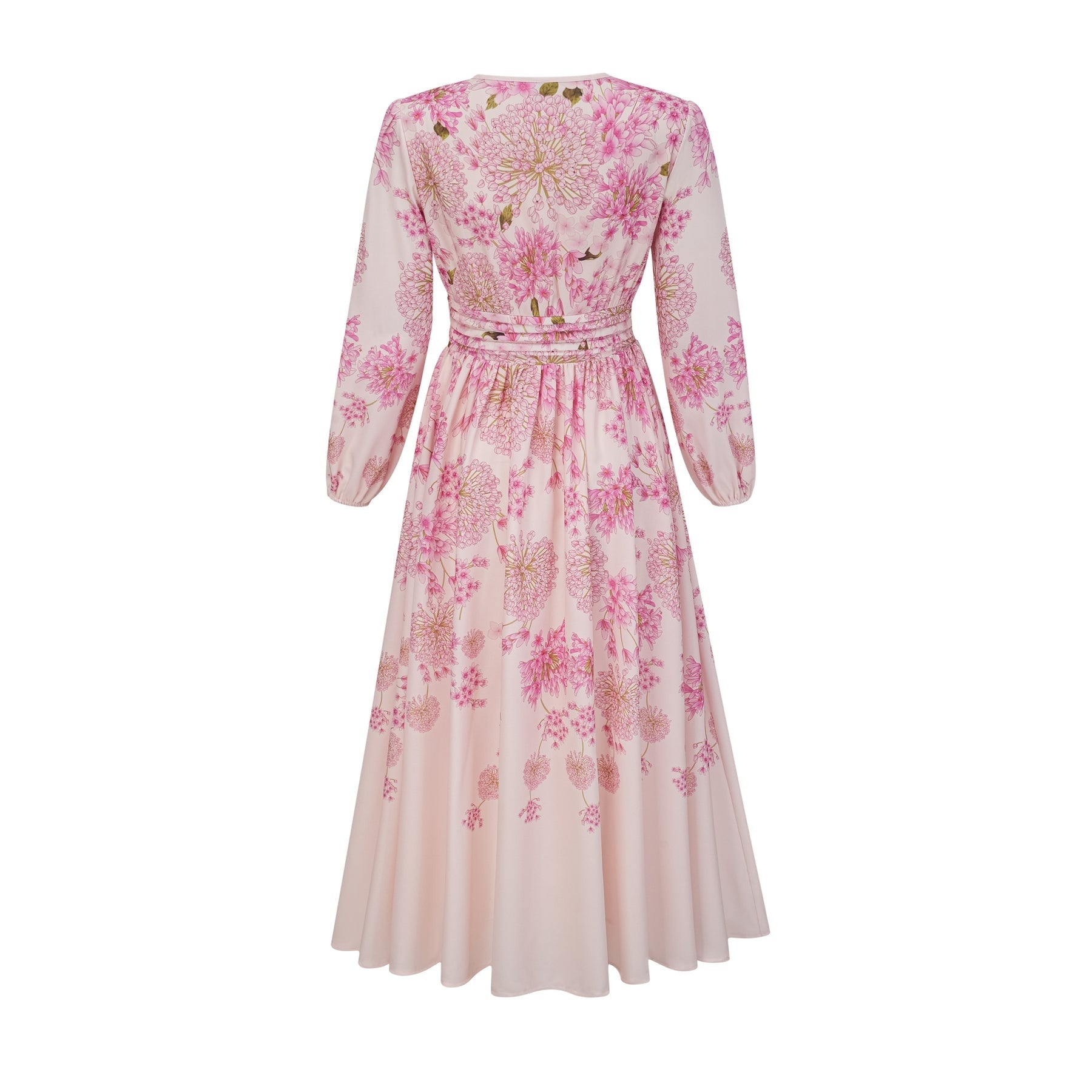 A pink midi dress with a floral print pattern worn by a model standing against a plain background