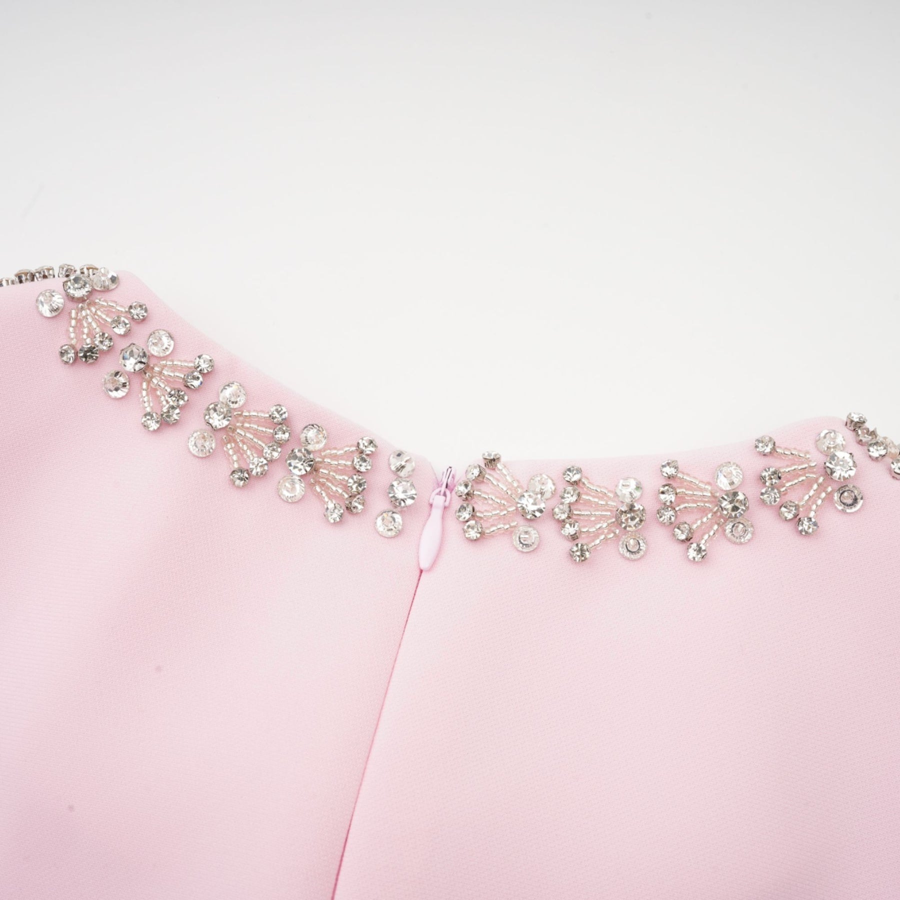 A pink midi dress with a large bow accent and crystal embellishments inspired by the Cassiopeia constellation