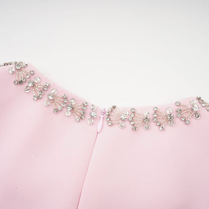 A pink midi dress with a large bow accent and crystal embellishments inspired by the Cassiopeia constellation