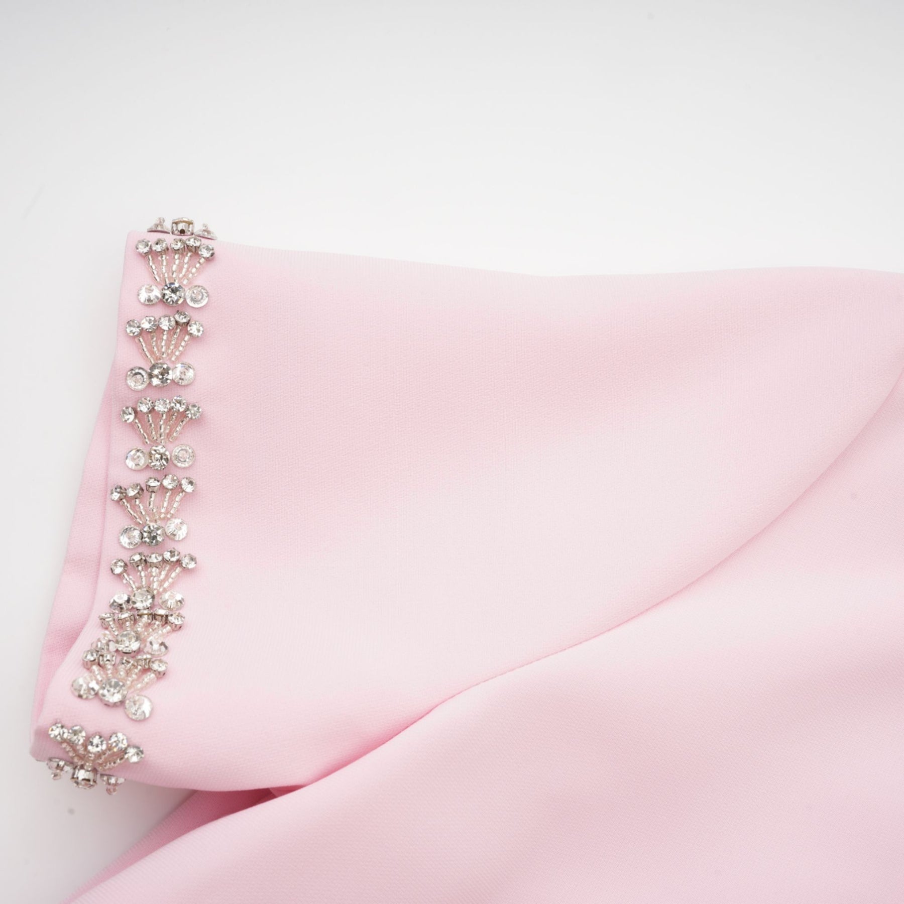 A pink midi dress with a large bow detail adorned with crystal accents inspired by the Cassiopeia constellation