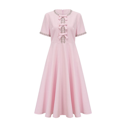 A pink midi dress with a large bow detail adorned with crystal accents named Cassiopeia