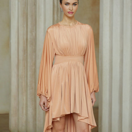A pink midi dress with an asymmetrical hemline and pleated details featuring a sleeveless design and fitted silhouette