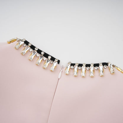 A pink midi dress with crystal embellishments and colorblocked design featuring the name Anais