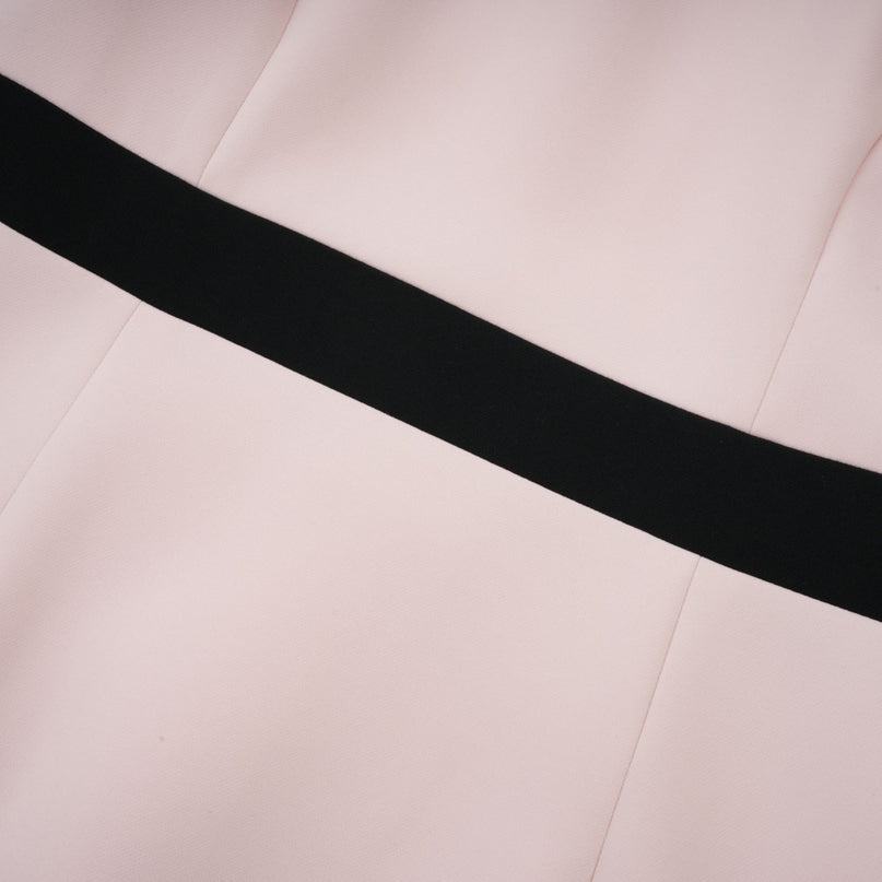 A pink midi dress with crystal embellishments and colorblocked design featuring the name Anais