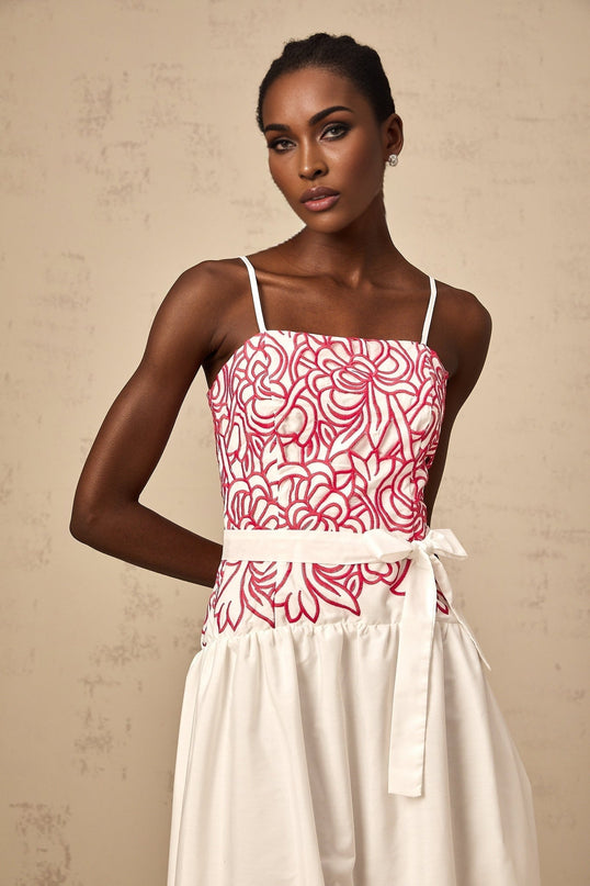 A pink midi dress with embroidery and cut out details named Beatrice