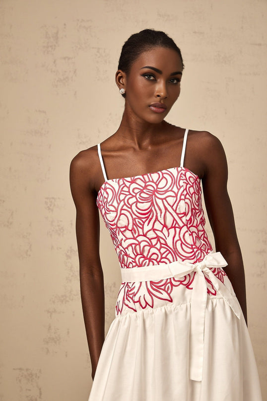 A pink midi dress with embroidery and cut out details named Beatrice