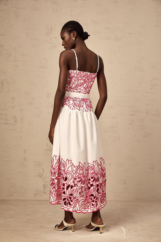 A pink midi dress with embroidery and cut out details named Beatrice