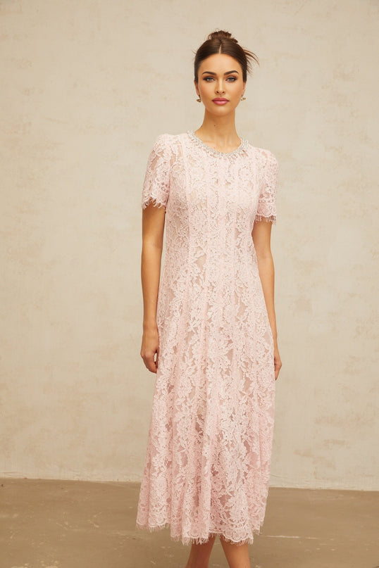 A pink midi dress with floral lace pattern and embellishments featuring a feminine silhouette and delicate design details