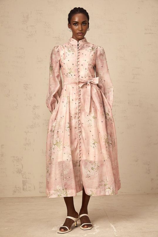 A pink midi dress with floral print and embellishments featuring a feminine Narcisse design