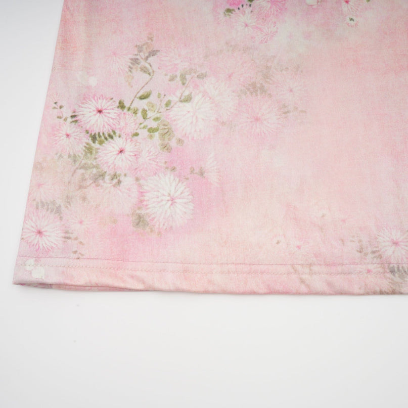 A pink midi dress with floral print and embellishments featuring a feminine Narcisse design