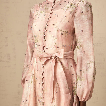 A pink midi dress with floral print and embellishments featuring a narcisse design