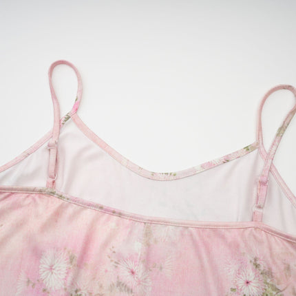 A pink midi dress with floral print and embellishments featuring a narcissus flower design